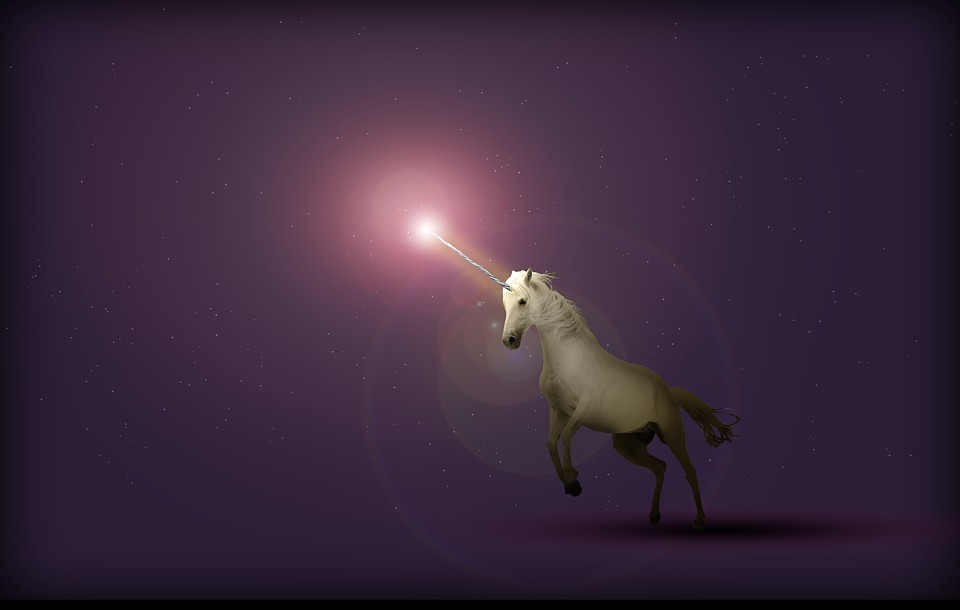white unicorn with glowing horn on purple background